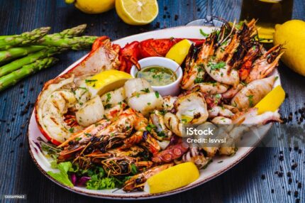 Pan-seared trout served on a white ceramic plate, garnished with fresh rosemary and lemon slices